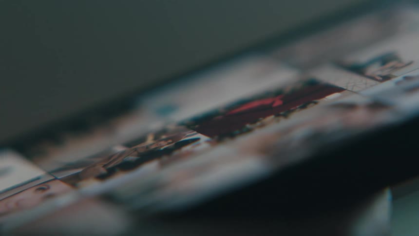 Closeup of a persons finger scrolling the screen and viewing photos on a cell phone
