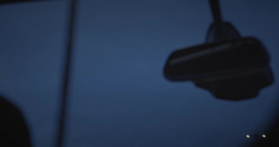 View from inside the car to the night sky with streetlights