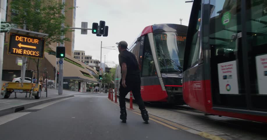 A man skating through the city streets during the day