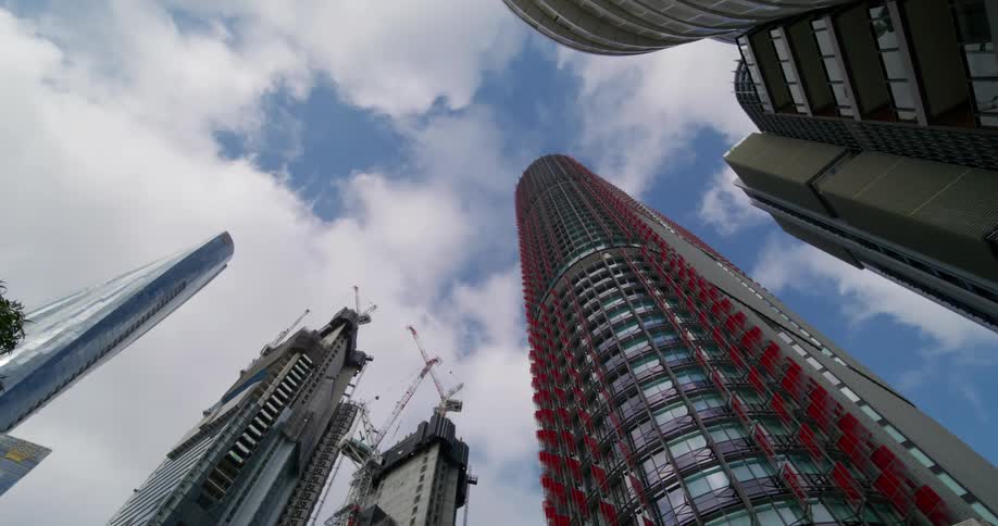 Upward view during blue sky daytime with a skyscraper in a metropolis