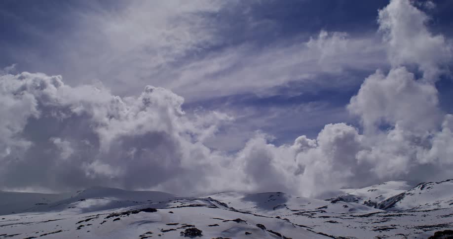 Dense clouds float over mountains