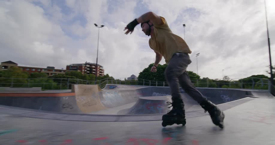 Man on a track performing tricks with roller skates