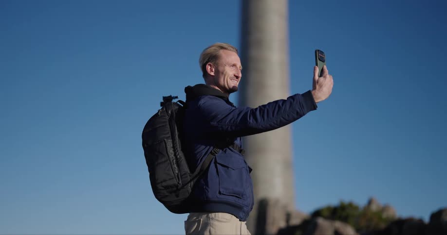 A man on a video call outdoor