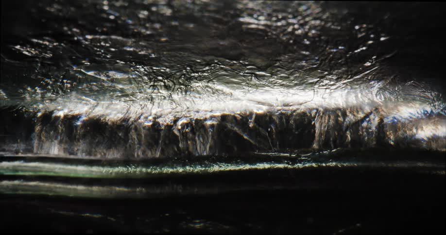 Light shines through flowing translucent fluid