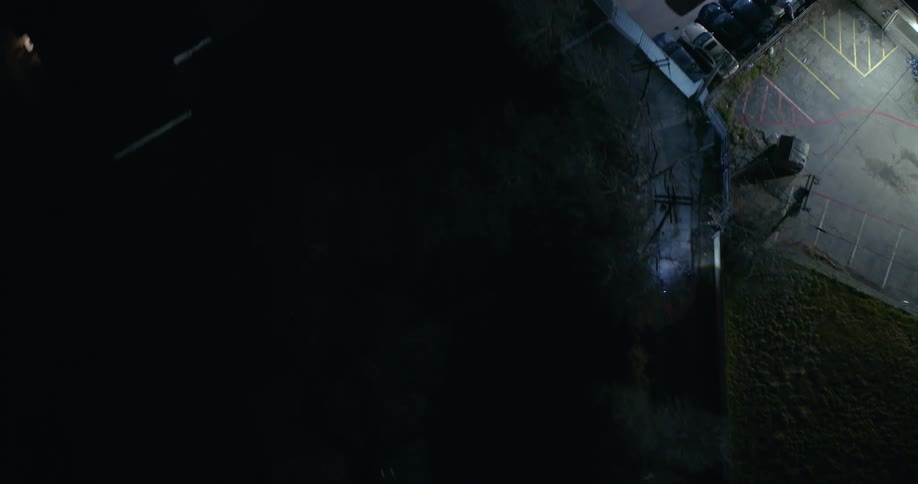 Aerial view of two motorcycles driving down a road at night