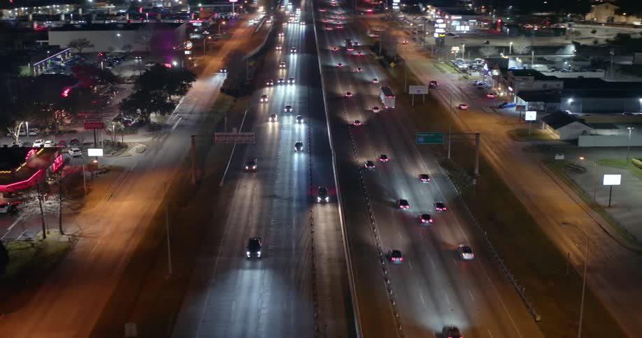 A steady flow of traffic moves quickly along a wide roadway