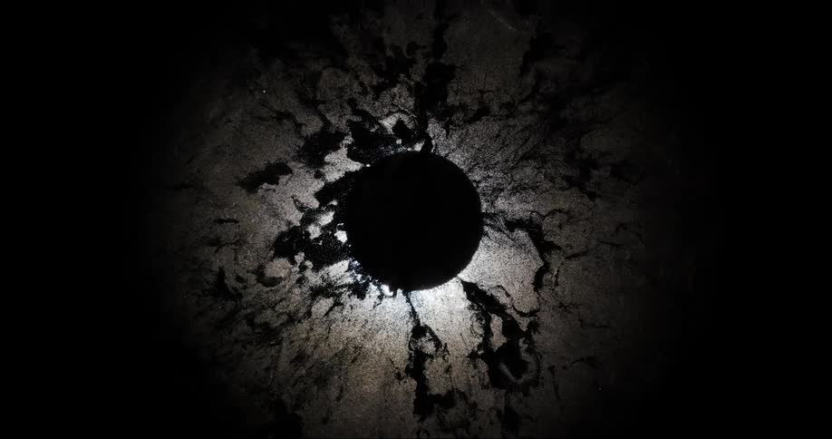 Abstract particles converge around spherical silhouette