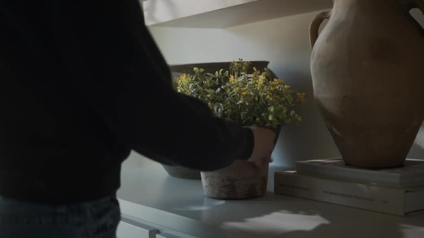 A woman is decorating her home