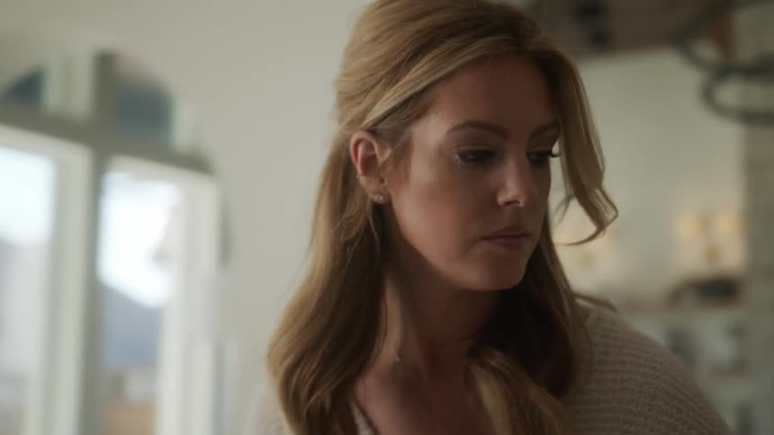 Portrait of a blonde woman indoors concentrated