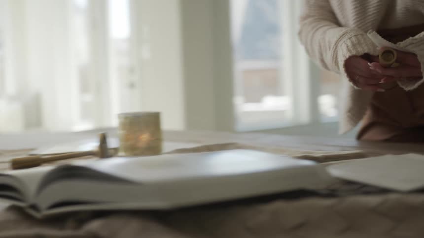 Woman standing comparing color textures of fabrics on table