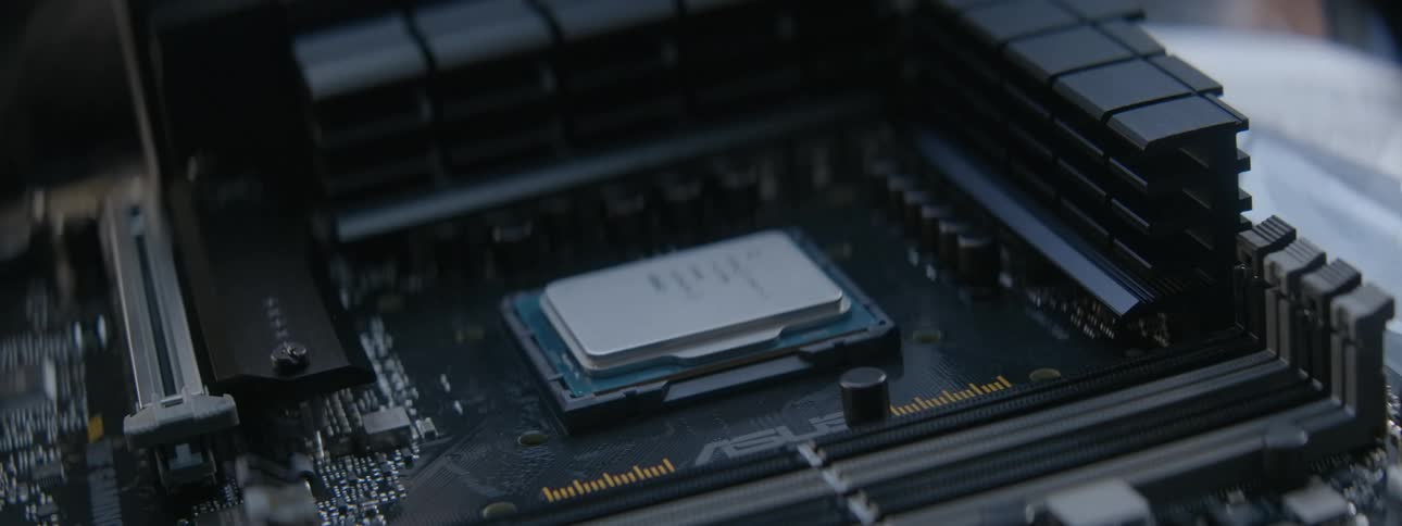 Aworker puts a chip into a motherboard