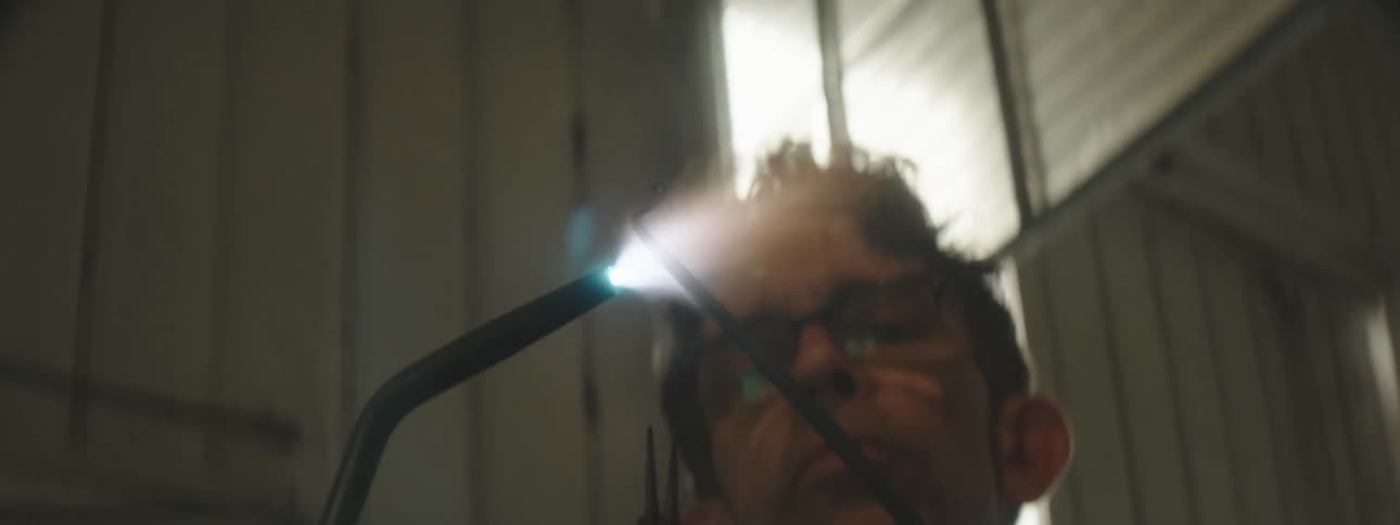 A worker lights a torch