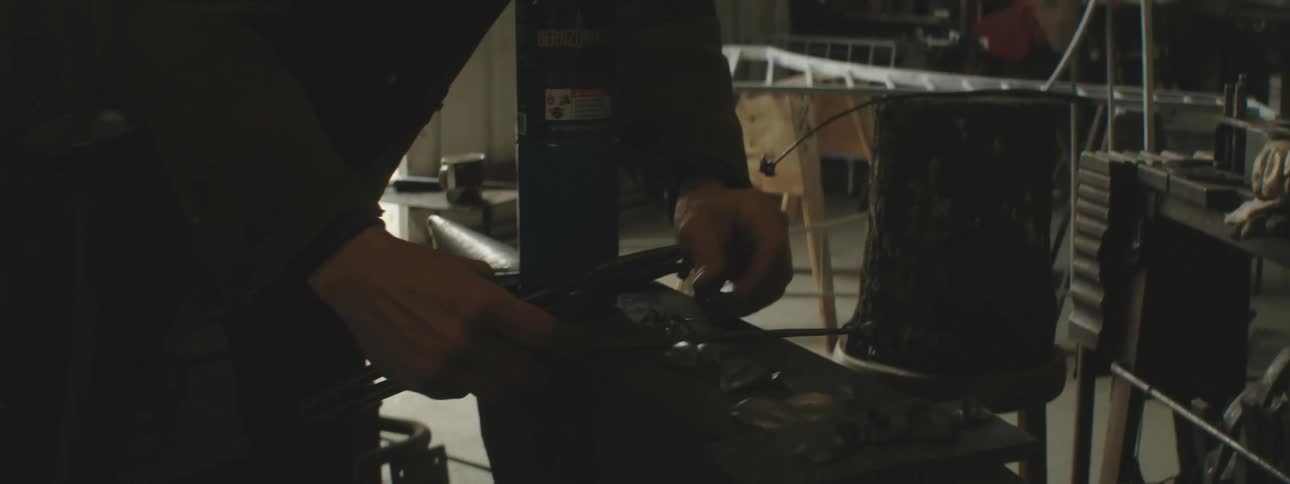 A person working on a dimly lit workshop