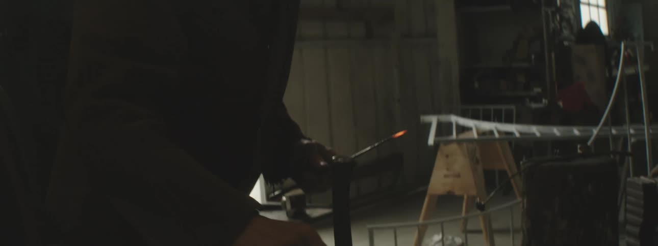 A welder heats up a piece of metal with his torch