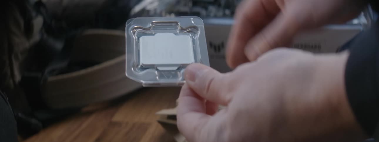 Close on a persons hands taking a computer processor out of cardboard