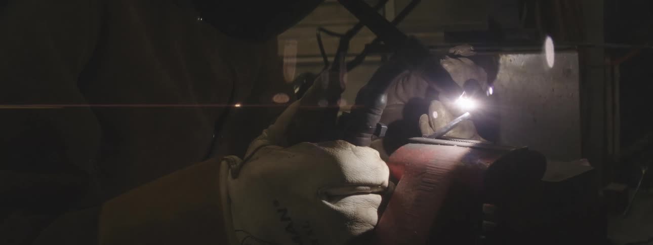 Hands of a man welding metal