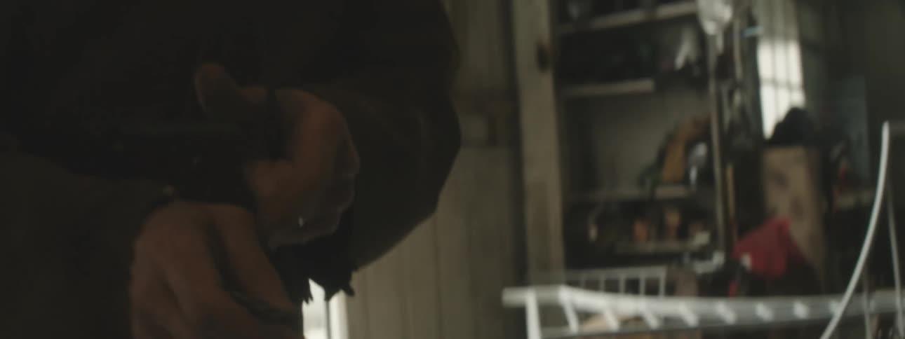 Closeup on a mans hands holding an iron rod and adapting other tools