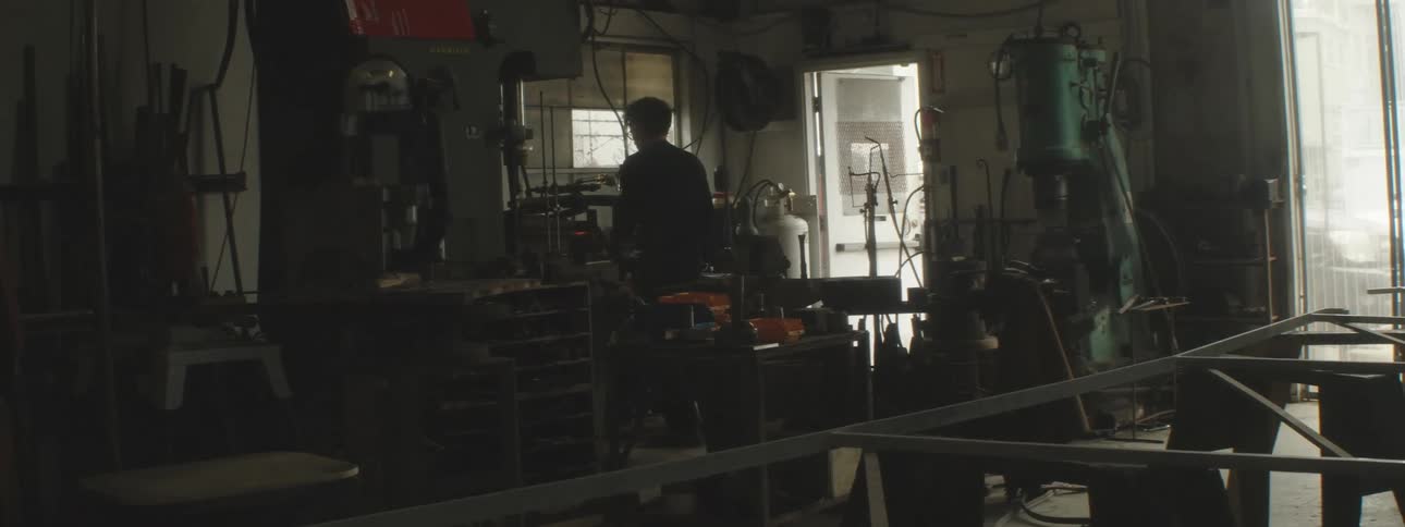 A blacksmith is working in his shop