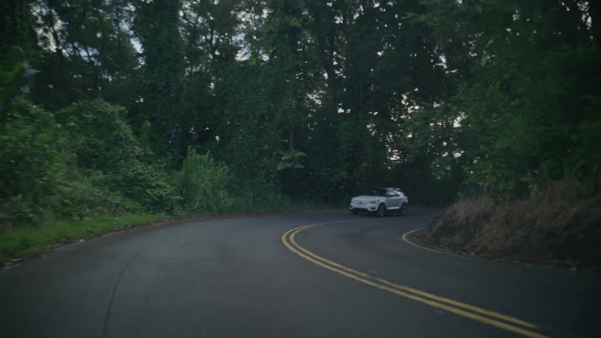 A car is turning down the long road