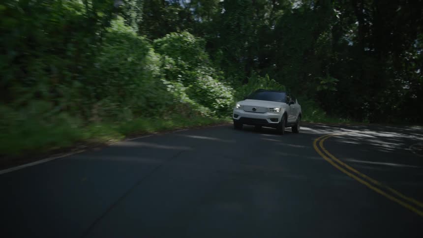 A car drives down the winding road