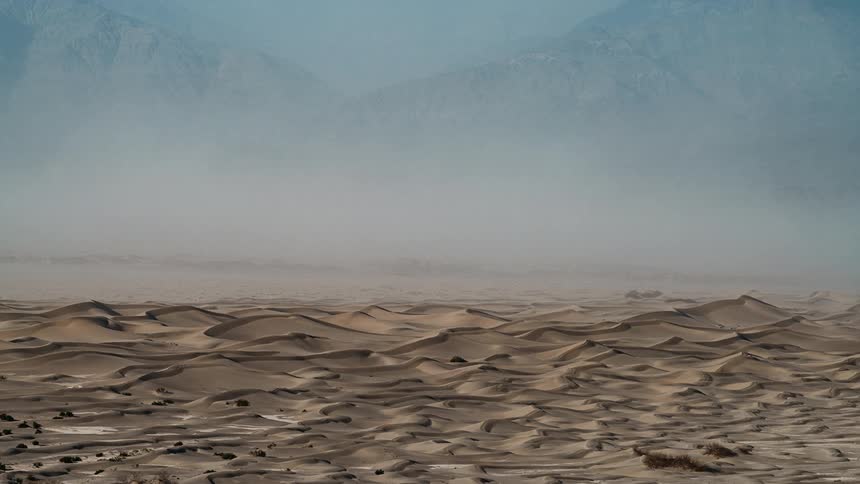 Winds drive sand across Mesquite dunes in Death Valley National Park