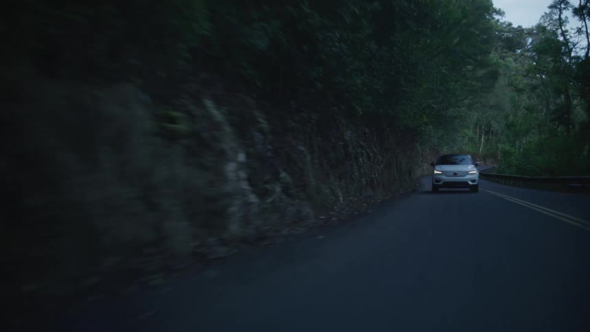 A car is driving down the long road