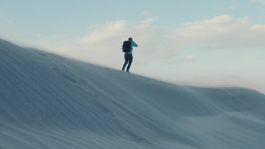 A man is hiking on Mesquite dunes