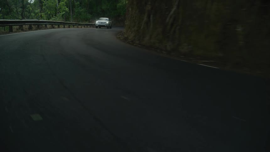 A car drives on the winding road