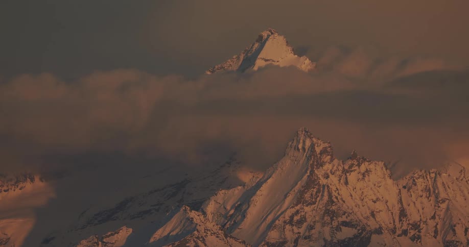 Clouds partially obscure a mountain