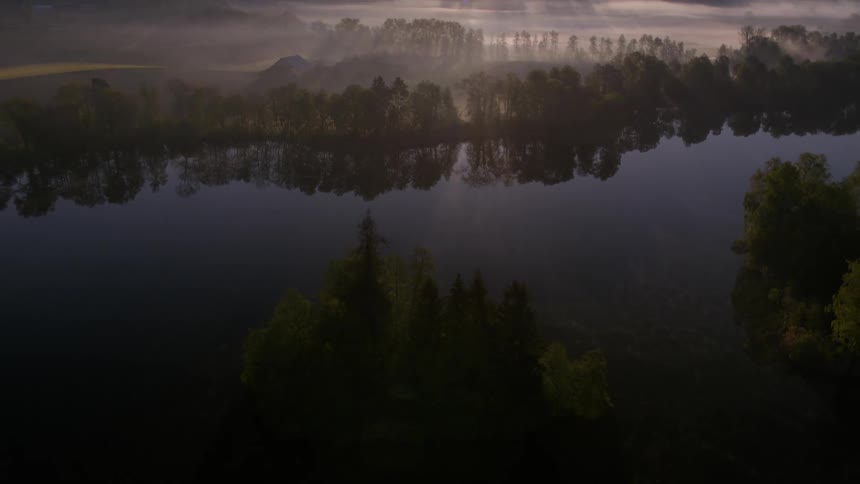 The land around the river is covered with fog