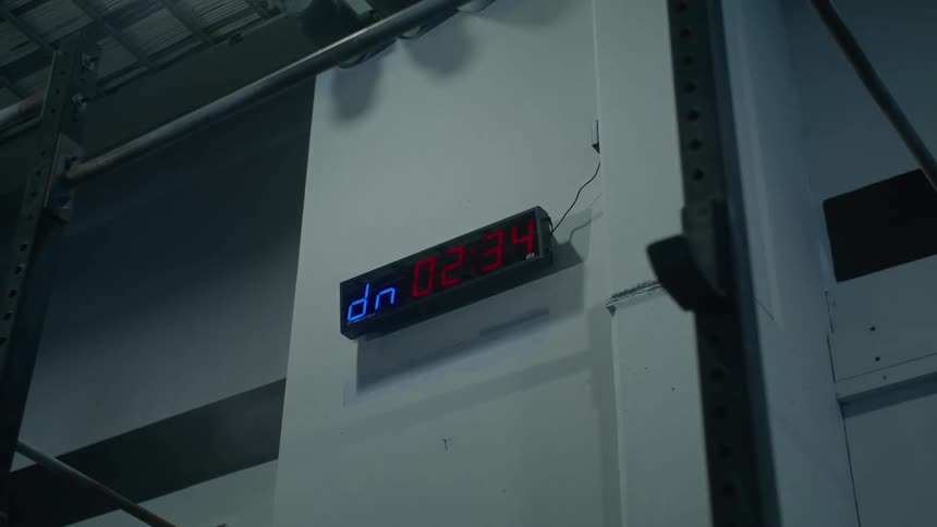 A timer placed on a wall count down from 5 mins