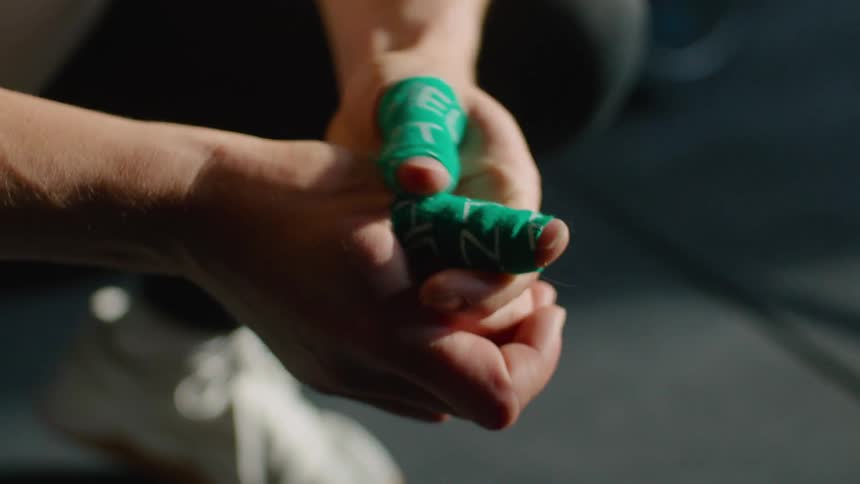 A person rubbing their fingers with a green shield