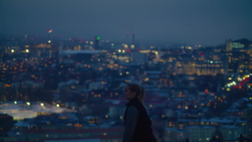 A teenage girl watches a bustling city