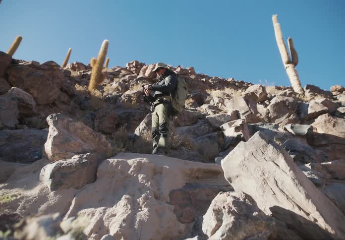 A man is hiking over the rocks