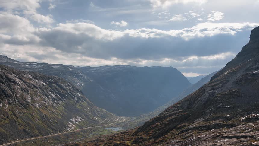 Landscape with mountain ranges in clouds passing in timelapse