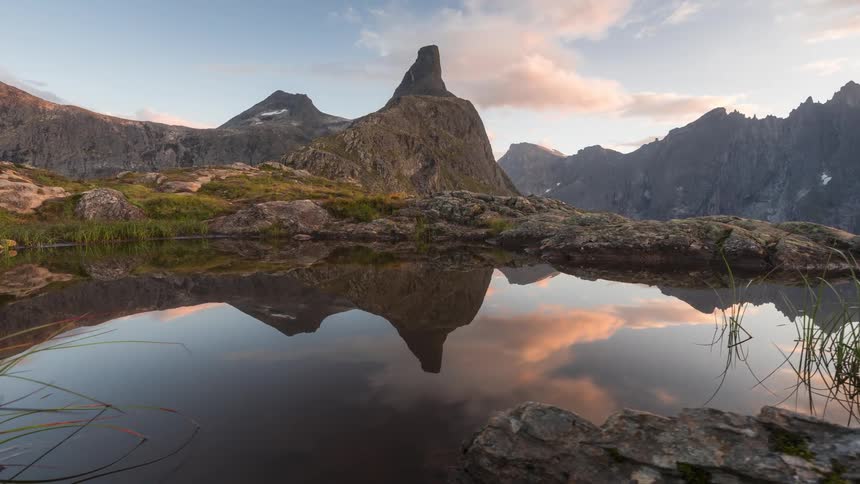 A lake surrounded by rocks and mountain