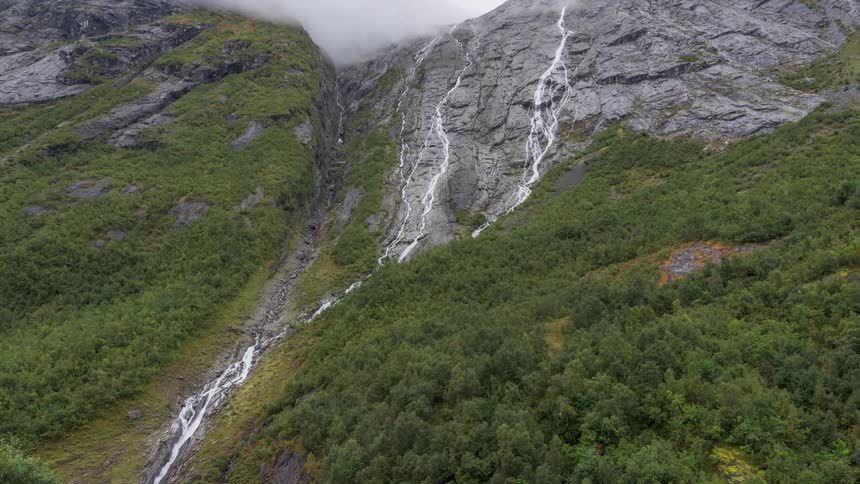 A waterfall running down the side of a mountain