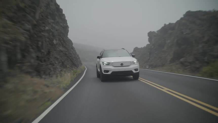 Suv vehicle traveling along a road on a foggy day