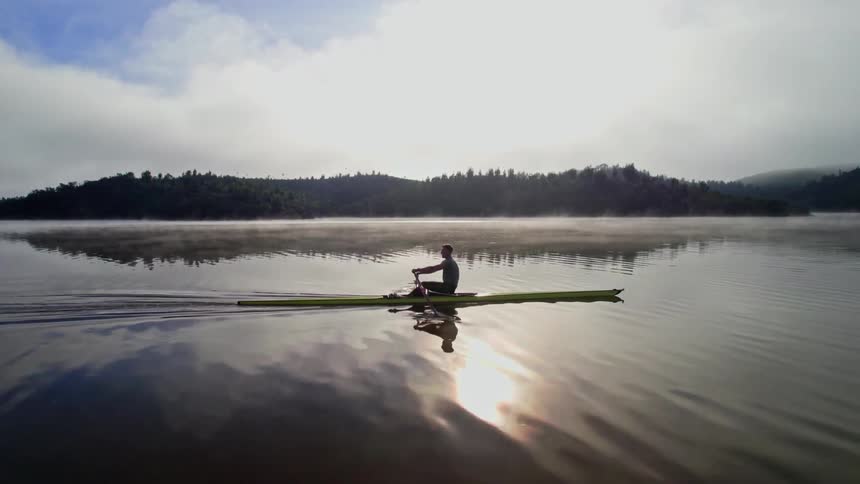 Olympic training routine in the early morning on tranquil lake