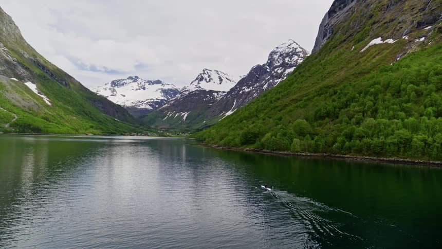 Aerial shot of a solitary man in boat revealing the grandeur of nature