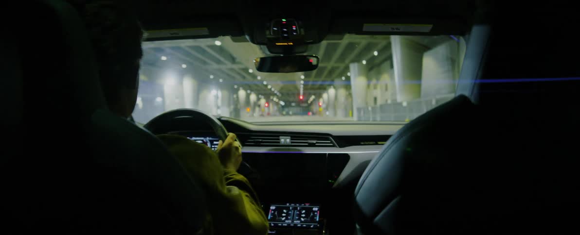 Man drives vehicle approaching intersection through a column supported structure