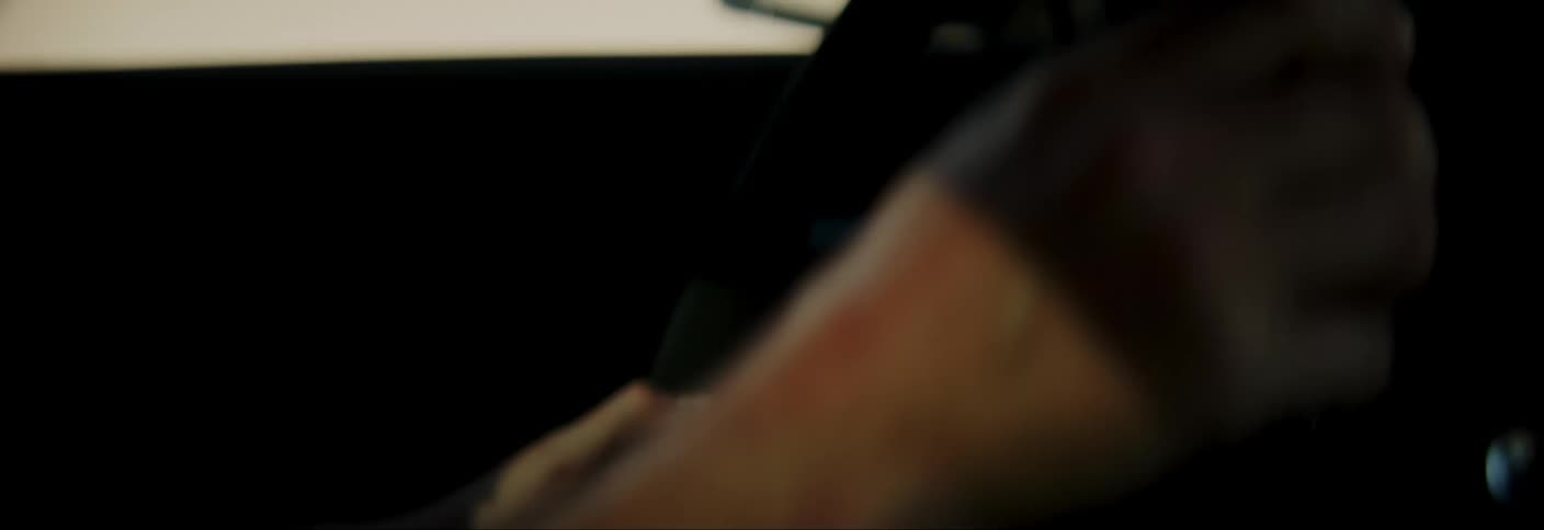 Close in the arms of a man driving a vehicle