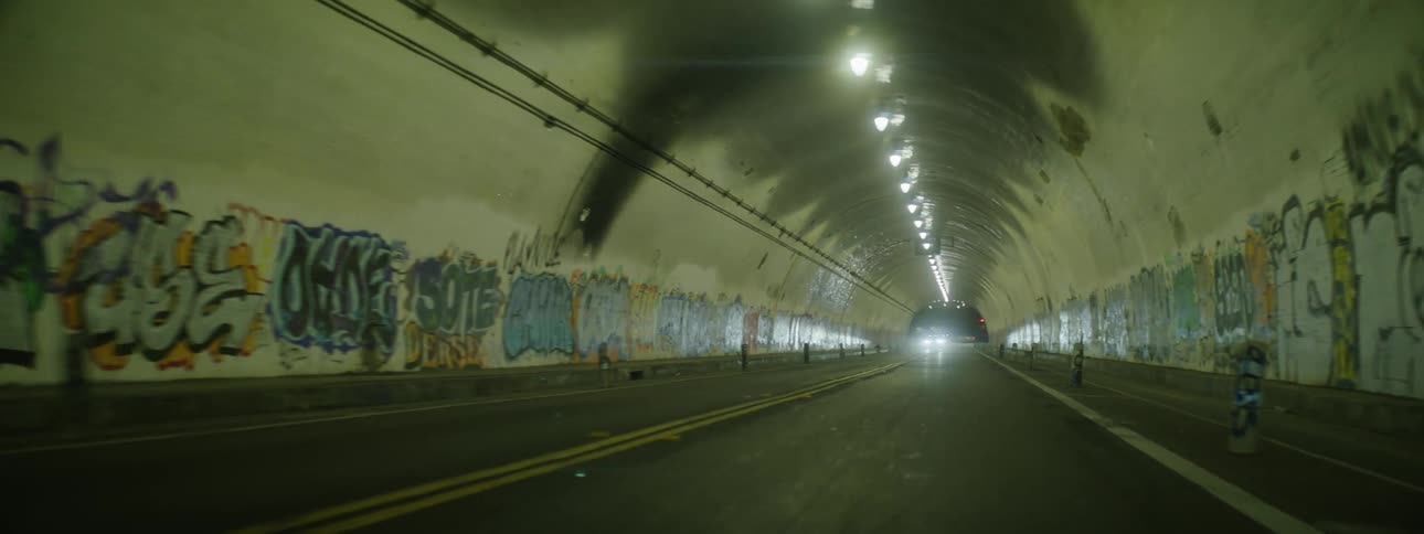 A car drives through a long tunnel