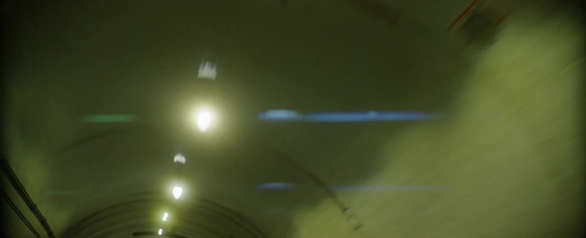 Silver audi sports car driving through a tunnel at night