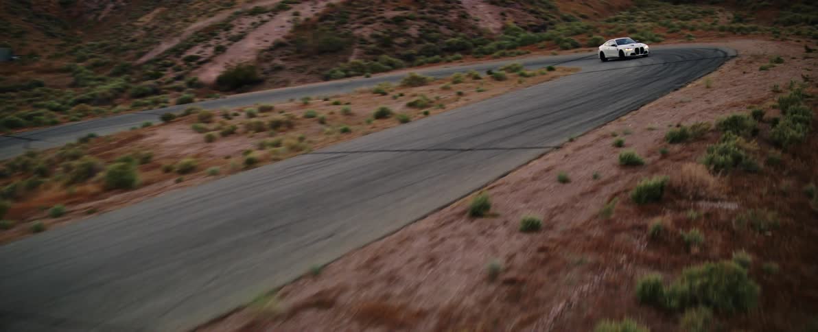 A car driving through a desert takes a sharp turn