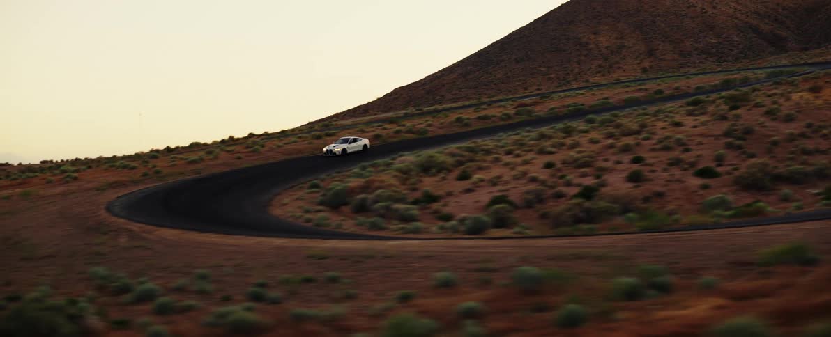 A car drives around the winding roads on the mountain