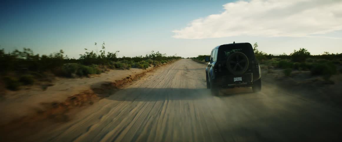 Jeep traveling along a dirt road in a natural environment