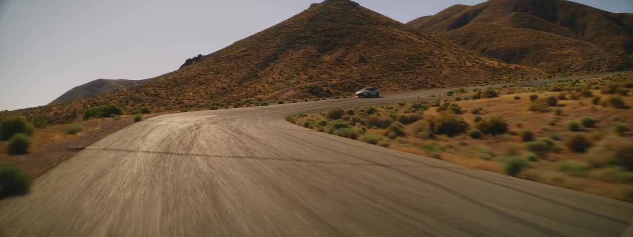 A car speeds around the long road
