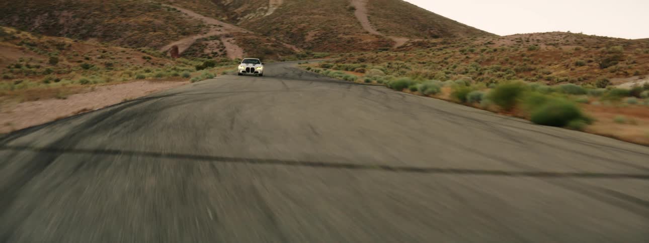 A speeding car on a desert road