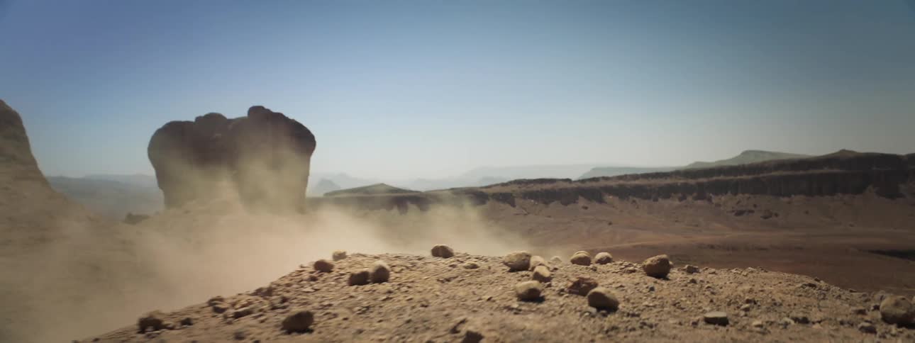 A man falls and rolls off the hill